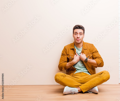 Konstfotografi young arabian man pointing to self with a confused and quizzical look, shocked a