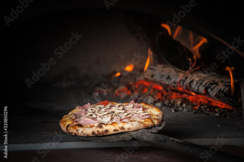 Pizza baking in traditional stone oven