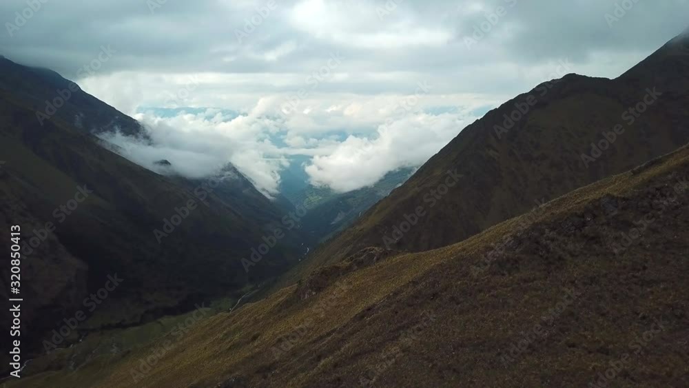 Aerial, drone shot over mountains, towards low clouds in a valley, on a cloudy day, in Andes, Peru, South America Aerial, drone shot over mountains, towards low clouds in a valley, on a cloudy day, in Andes, Peru, South America