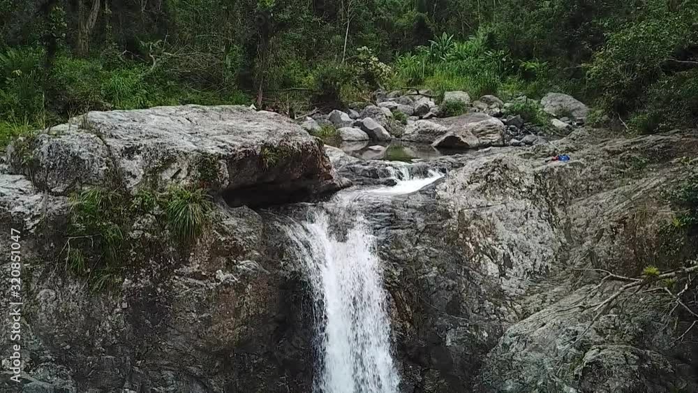 Creek Falls in Tropical Rainforest. Slowmotion Aerial View of Natural Waterfall in Puerto Rico Creek Falls in Tropical Rainforest. Slowmotion Aerial View of Natural Waterfall in Puerto Rico