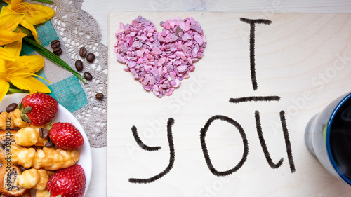 strawberry, cookie hearts with a Cup of black coffee beans, with yellow flowers and a note I LOVE you happy Valentine's day mother