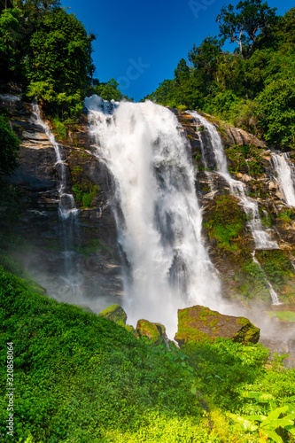Wachirathan Waterfall at Doi Inthanon National Park, Mae Chaem District, Chiang Mai Province, Thailand. Fresh flowing water in tropical rainforest. Green trees, vibrant colors, tranquility