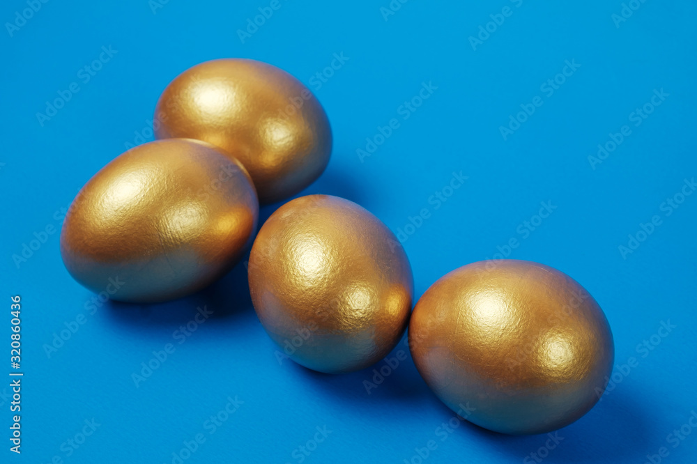 Golden eggs on a blue surface Golden eggs on a blue surface