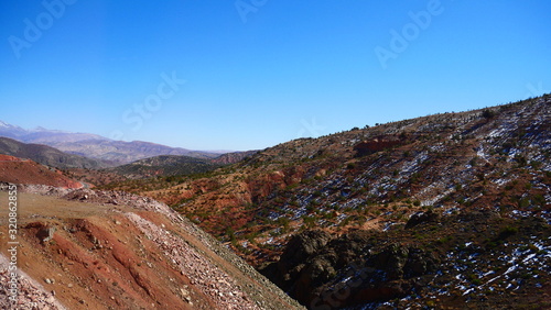 Bright landscape of Morocco, breathtaking curves of mountains, stunning combination of hills & farm land,inadvertent distribution of houses & huts, raw impression of pure nature.