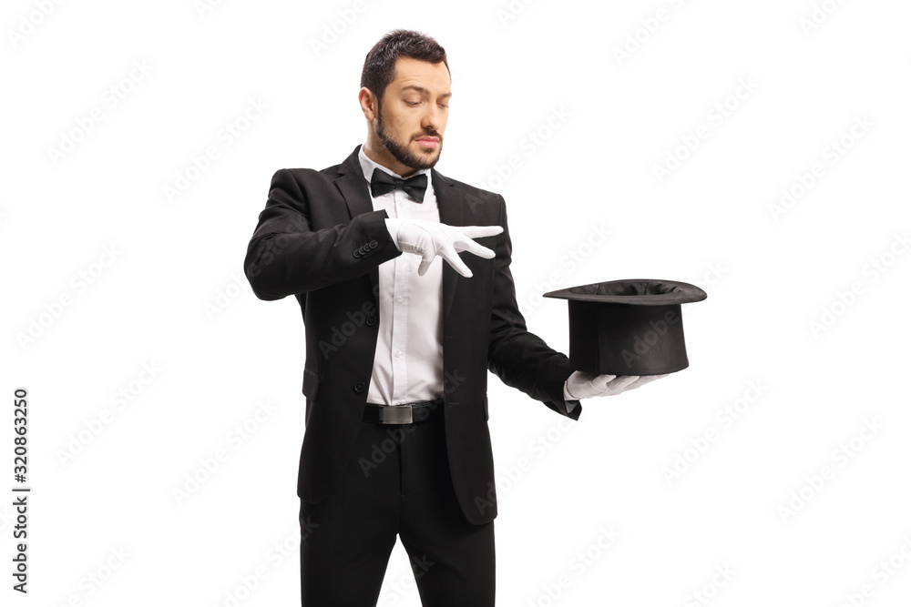 Fototapeta premium Male magician performing a trick with hands and a top hat