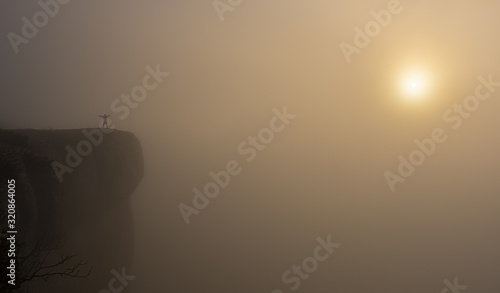 man on the edge of the cliff with the sun at dawn, Balcon de Pilatos, Sierra de Urbasa, Navarra photo