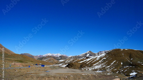 Bright landscape of Morocco, breathtaking curves of mountains, stunning combination of hills & farm land,inadvertent distribution of houses & huts, raw impression of pure nature.