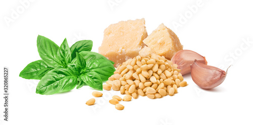 Green basil leaves, parmesan cheese, pine nuts and garlic cloves isolated on white background