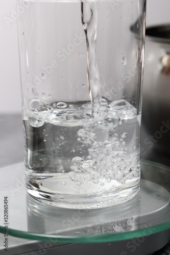 Pouring and Weighing Water on Kitchen Scale