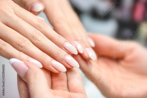 Perfect manicure care. Woman hands care and relaxing. Beauty skin nails salon. © Milan
