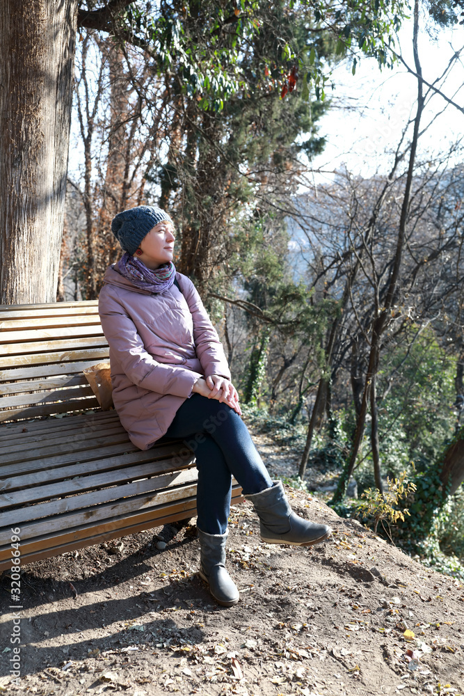 Fototapeta premium Woman sitting on bench