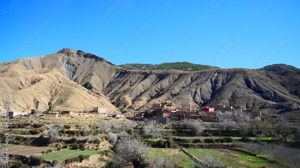 Bright landscape of Morocco, breathtaking curves of mountains, stunning combination of hills & farm land,inadvertent distribution of houses & huts, raw impression of pure nature.