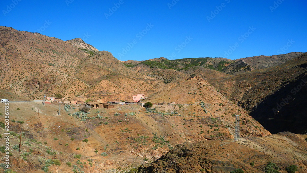 Bright landscape of Morocco, breathtaking curves of mountains, stunning combination of hills & farm land,inadvertent distribution of houses & huts, raw impression of pure nature. Bright landscape of Morocco, breathtaking curves of mountains, stunning combination of hills & farm land,inadvertent distribution of houses & huts, raw impression of pure nature.
