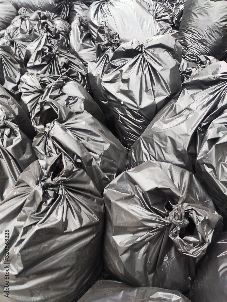black garbage bags piled together. background of plastic black bags