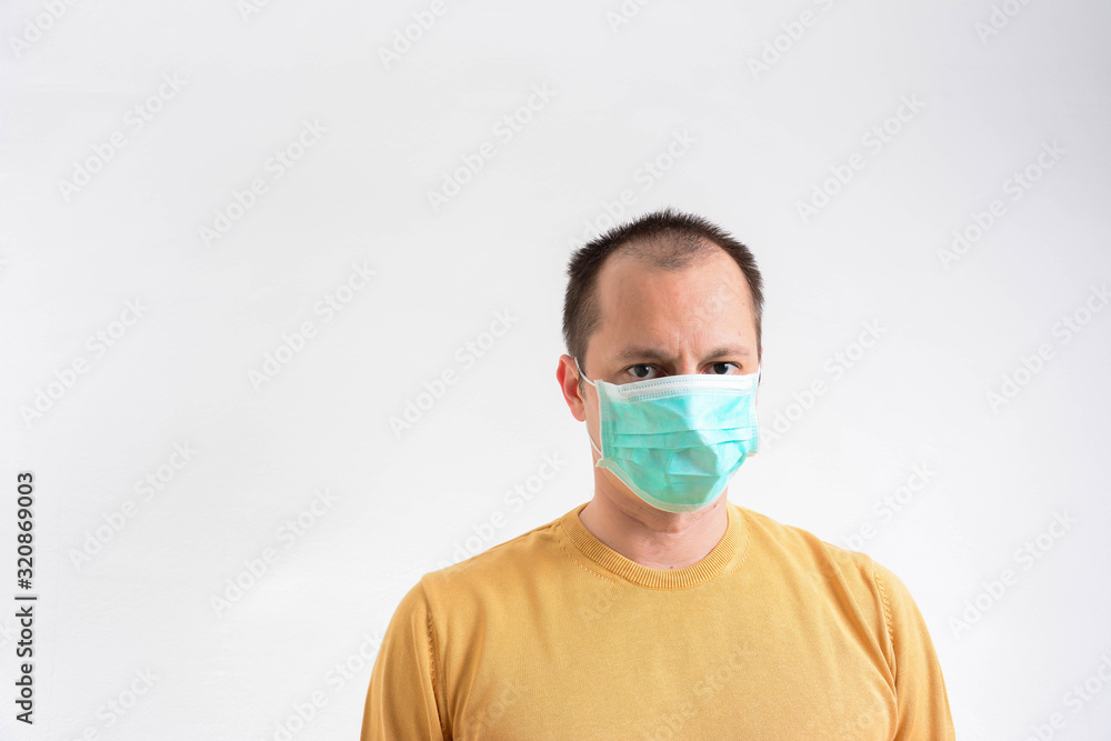 Closeup with the face of a man wearing medical or surgical mask to Avoid close contact with sick people. Isolated on white background. copy space. Closeup with the face of a man wearing medical or surgical mask to Avoid close contact with sick people. Isolated on white background. copy space.