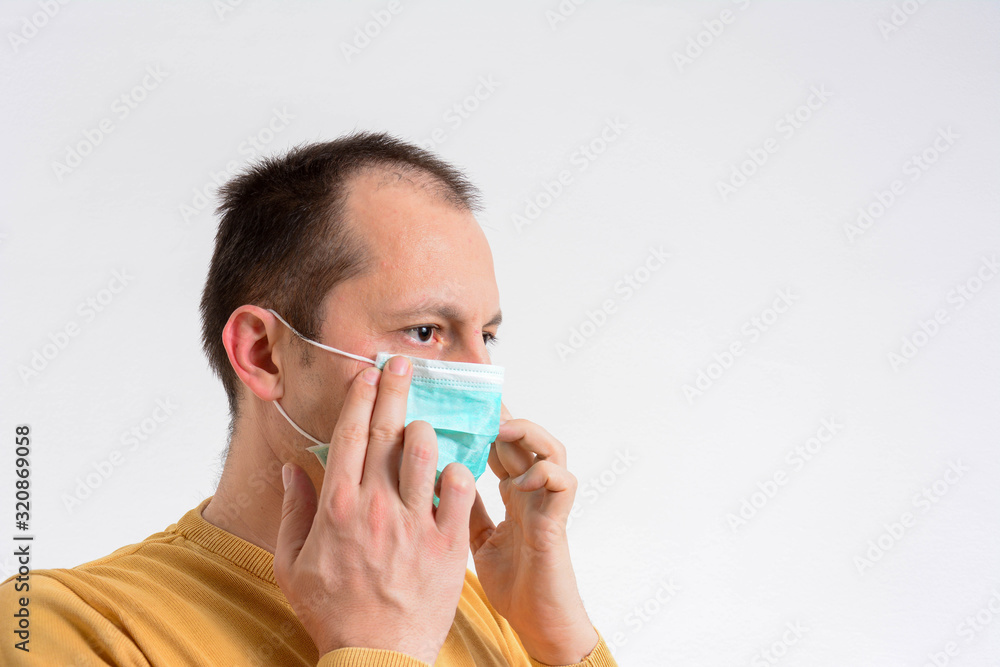 Man in a respiratory mask with a cold. Male have Shortness of breath. copy space. Isolated on white background. Man in a respiratory mask with a cold. Male have Shortness of breath. copy space. Isolated on white background.