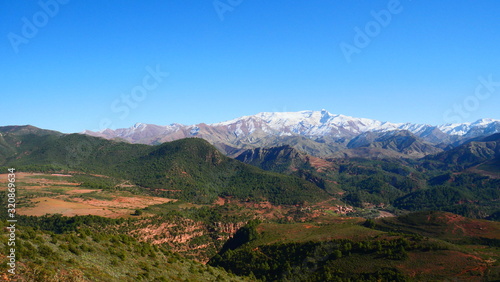 Bright landscape of Morocco, breathtaking curves of mountains, stunning combination of hills & farm land,inadvertent distribution of houses & huts, raw impression of pure nature.