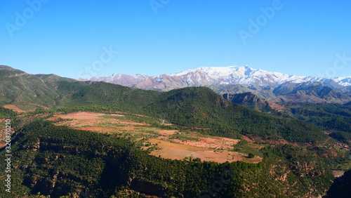 Bright landscape of Morocco, breathtaking curves of mountains, stunning combination of hills & farm land,inadvertent distribution of houses & huts, raw impression of pure nature.