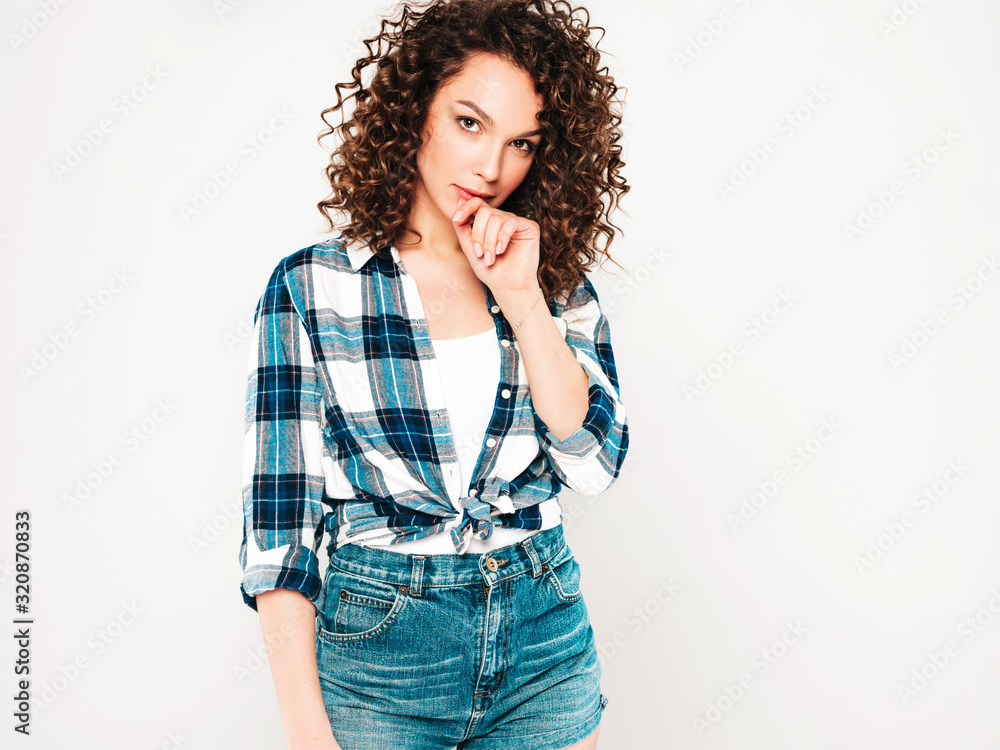 Portrait of beautiful smiling model with afro curls hairstyle dressed in summer hipster clothes.Sexy carefree girl posing in studio on gray background.Trendy funny and positive woman Portrait of beautiful smiling model with afro curls hairstyle dressed in summer hipster clothes.Sexy carefree girl posing in studio on gray background.Trendy funny and positive woman