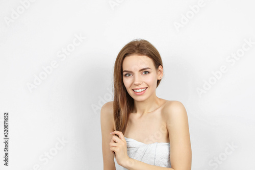 Beautiful smiling woman in a bath towel