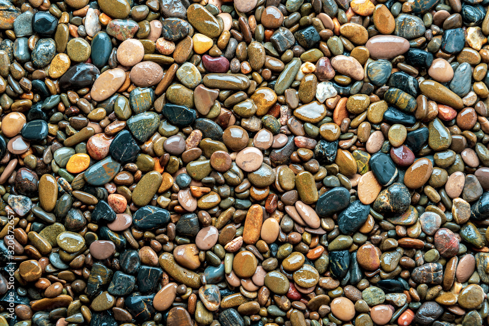 Wet sea pebble texture as background Wet sea pebble texture as background