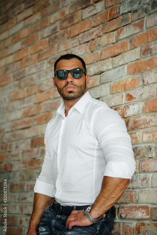 A sexy athlete with a naked torso is wearing glasses. Rest, healthy lifestyle A sexy athlete with a naked torso is wearing glasses. Rest, healthy lifestyle