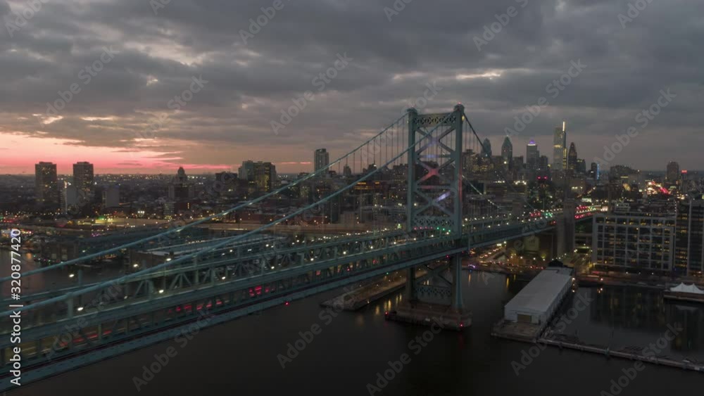 Ben Franklin Bridge, aerial hyperlapse, timelapse of traffic, dramatic sunset and skyline of Philadelphia, PA, Philly metro city lights, drone view Ben Franklin Bridge, aerial hyperlapse, timelapse of traffic, dramatic sunset and skyline of Philadelphia, PA, Philly metro city lights, drone view