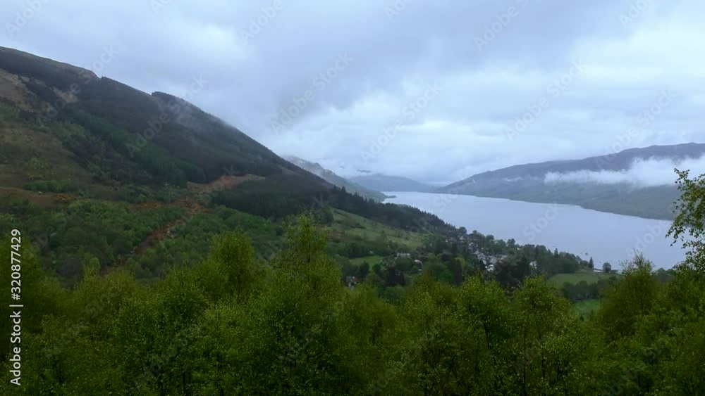 Dolly-in zoom drone shot of scottish highland mountain lake Dolly-in zoom drone shot of scottish highland mountain lake