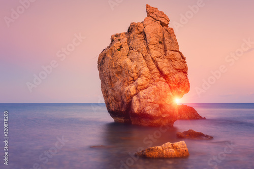 Amazing sunset seascape, famous Aphrodite's Rock or Petra tou Romiou, the birthplace of Goddness Aphrodite, Paphos, Cyprus. Outdoor travel background, popular tourist location photo