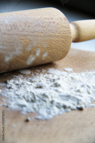 flour on wooden board and rolling pin