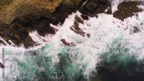 Aerial view of the waves at the coast of arealonga punta do castro, tilt up photo