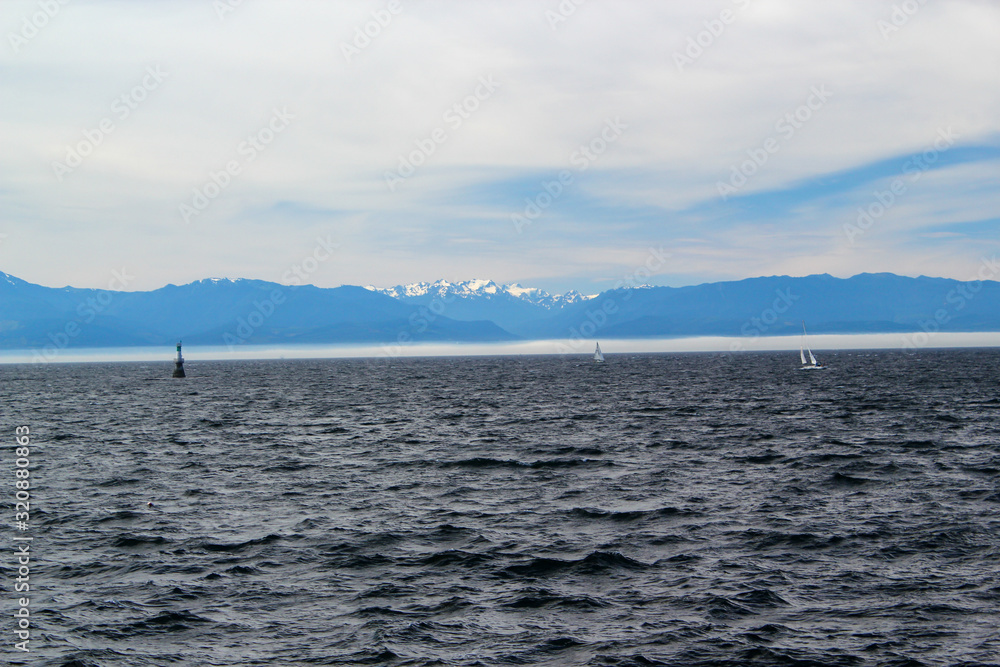 Dark sea / in the Background white mountains