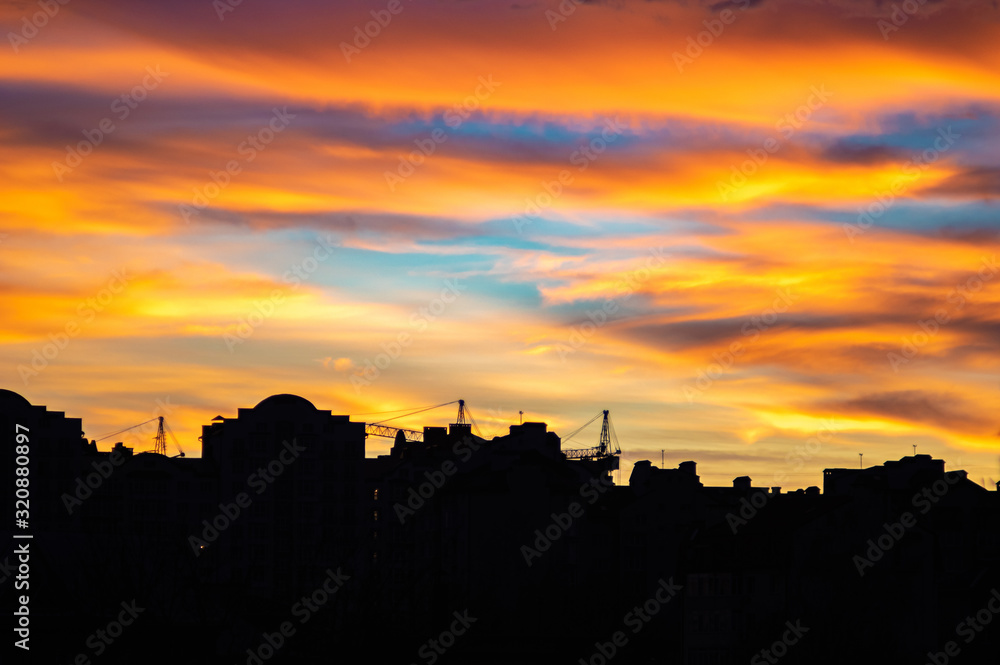 Colorful sunset sky over the houses of the city Colorful sunset sky over the houses of the city