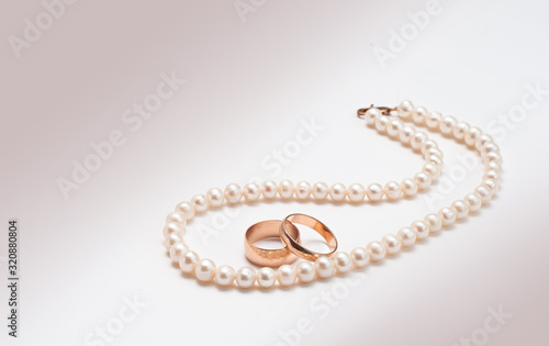 Wedding rings and white pearls