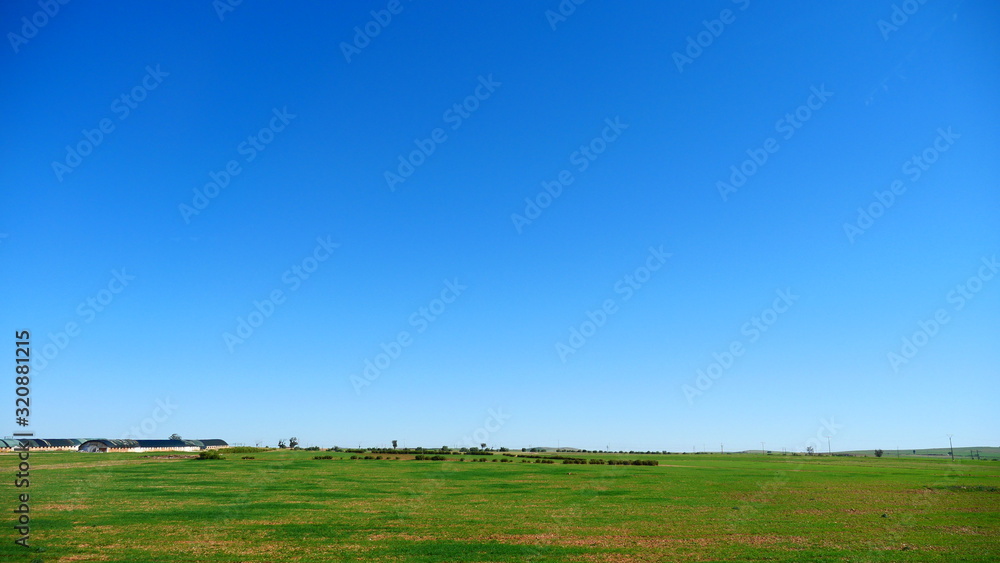 Naklejka premium Bright landscape of Morocco, breathtaking curves of mountains, stunning combination of hills & farm land,inadvertent distribution of houses & huts, raw impression of pure nature.