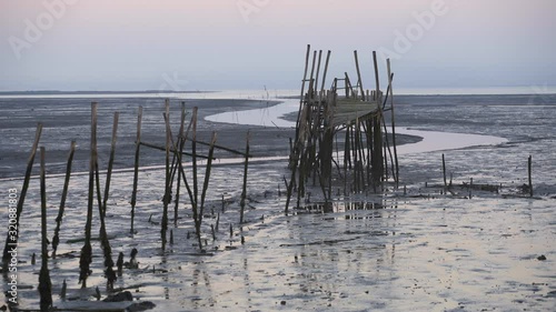 Carrasqueira Palafitic Pier in Comporta, Portugal at sunset photo