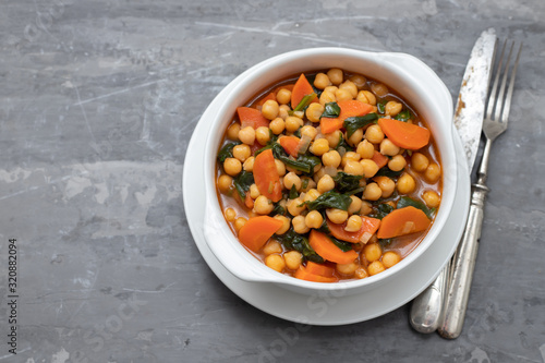chick-pea with carrot and spinach on white bowl on ceramic backgeound