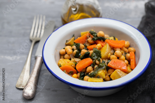 chick-pea with carrot and spinach on white bowl on ceramic backgeound