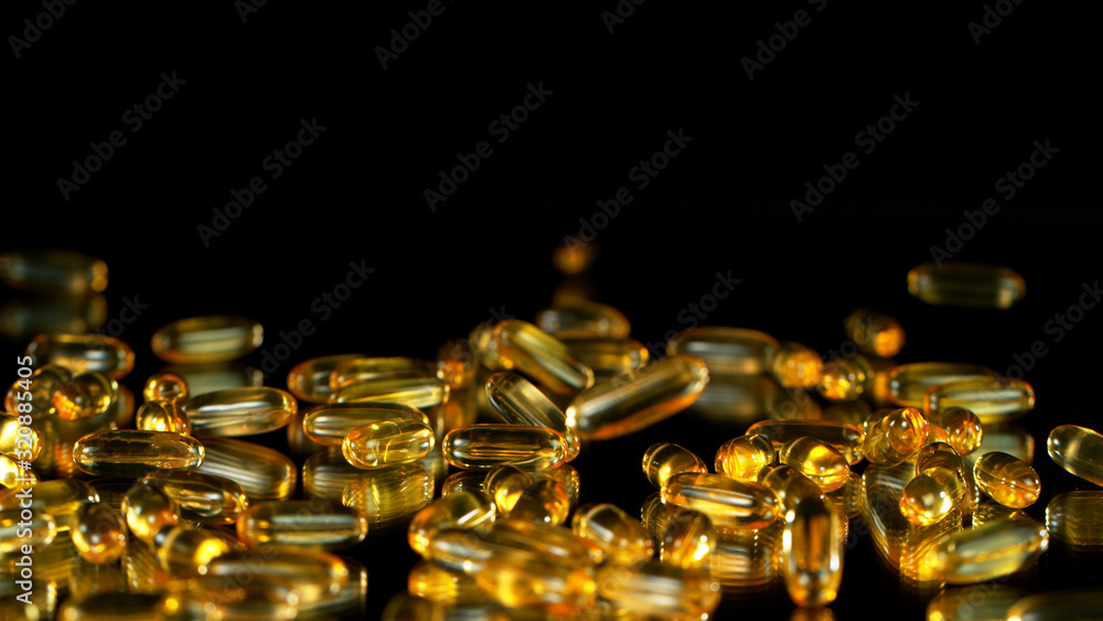 Freeze motion of fish fat pills on black Freeze motion of fish fat pills on black