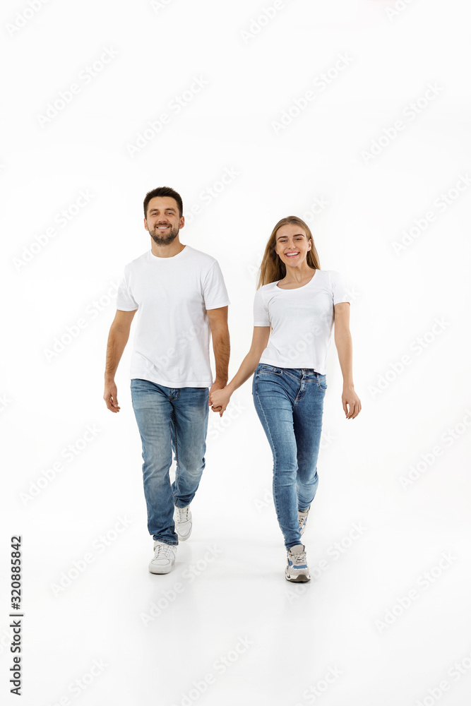 full length portrait of happy couple in casual outfit walking forward together on white background full length portrait of happy couple in casual outfit walking forward together on white background