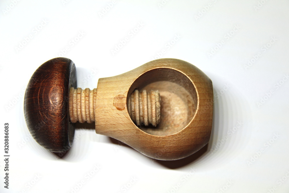 Wooden nutcracker is a mechanical device for cracking nuts. Stock Photo Adobe Stock