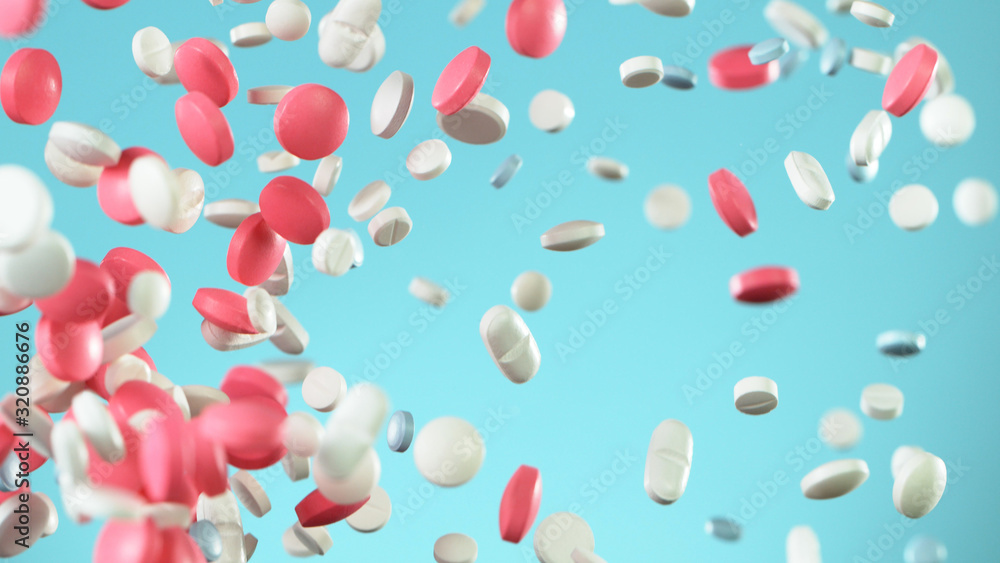 Freeze motion of flying pills on white background