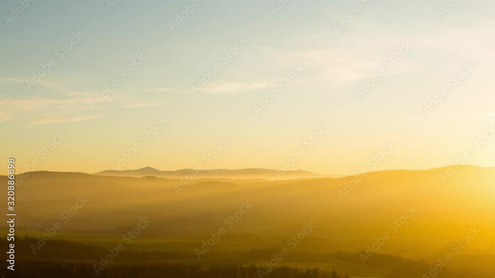 Time lapse of Snezka, Karkonosze mountains, during a foggy yellow sunset Time lapse of Snezka, Karkonosze mountains, during a foggy yellow sunset