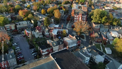 Church steeple and large Catholic school in Lancaster Pennsylvania, downtown inner city urban aerial view, birds eye drone shot, traffic driving on street photo