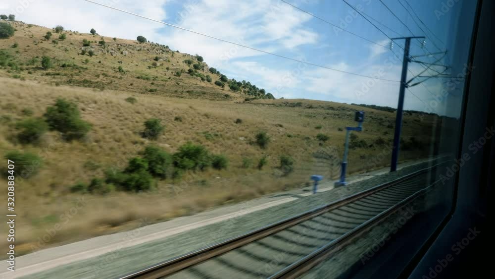 Railroad track. Scenic landscape view from the high speed train driving through suburb of Spain. 4K Railroad track. Scenic landscape view from the high speed train driving through suburb of Spain. 4K