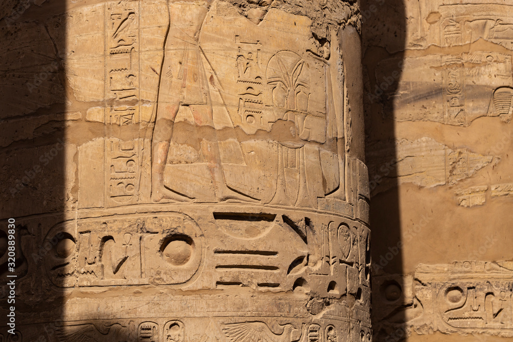 Karnak Temple, complex of Amun-Re. Embossed hieroglyphics on columns. Great Hypostyle Hall. Luxor Governorate, Egypt. Karnak Temple, complex of Amun-Re. Embossed hieroglyphics on columns. Great Hypostyle Hall. Luxor Governorate, Egypt.