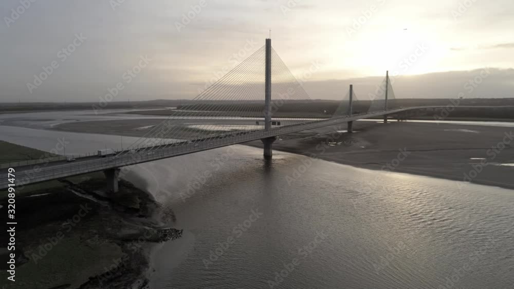Aerial dolly left view across River Mersey Gateway suspension bridge at sunrise. Aerial dolly left view across River Mersey Gateway suspension bridge at sunrise.