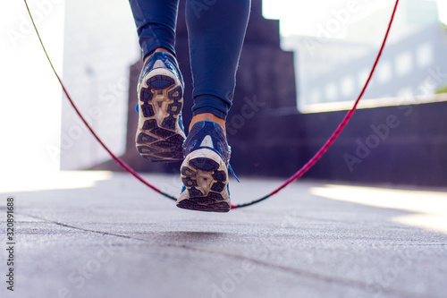 Close up of an athletic person's feet jumping rope outdoor photo