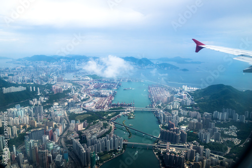 Canvas Print Aerial view of Hong Kong islands with skyscapers and industry from a flying airp