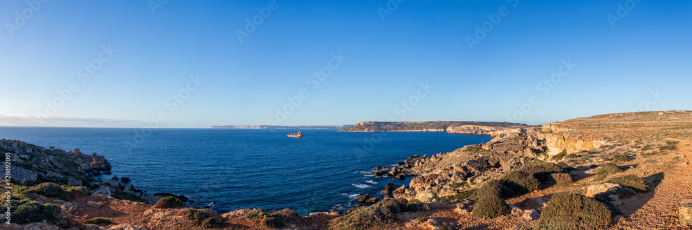 Panorama of the coastline cliffs of the Golden Bay at sunset, Mediterranean sea island of Malta